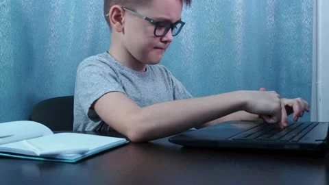 The boy with glasses doesn't get the task. chagrin on his face. he pushes the Stock Footage 144683446