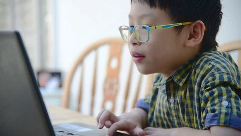 Boy with glasses playing games on computer. Stock Footage 69894927