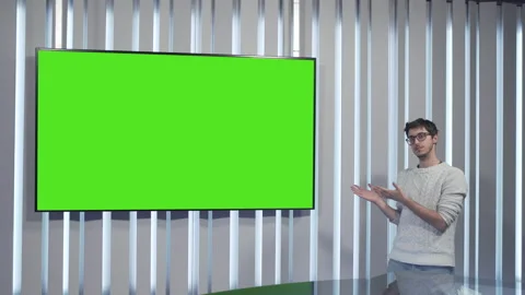 Boy with glasses points to the green screen and nods Stock Footage 144246353