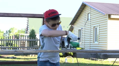 The boy with glasses is preparing to cut the board Stock Footage 111671230