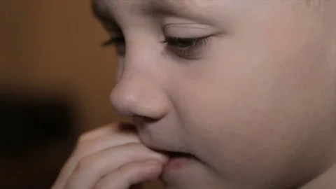 The boy gnaws at the fingernails Stock Footage 73421575