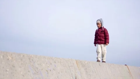 Boy goes on a concrete wall Stock Footage 75615855