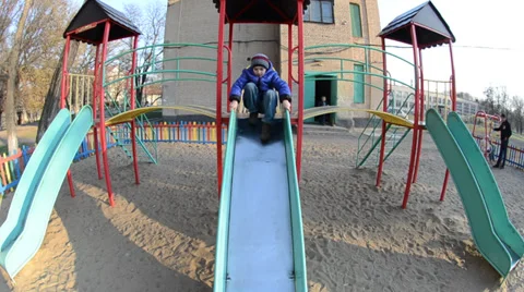 A boy goes down from child's hill Stock Footage 36784805