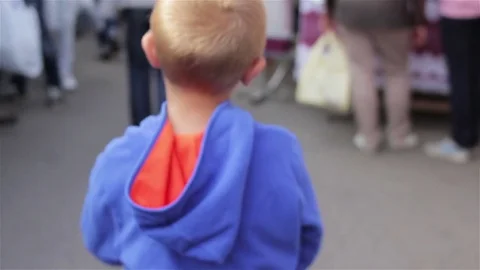 The boy goes on the market Stock Footage