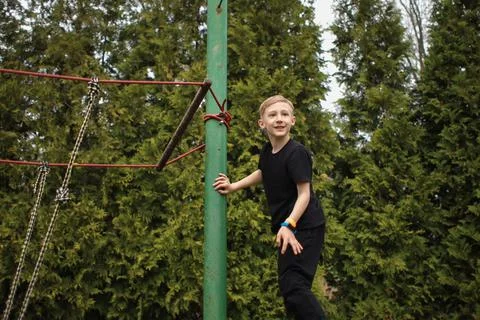 The boy goes through an obstacle course, goes in for active sports, walks on  Stock-Fotos