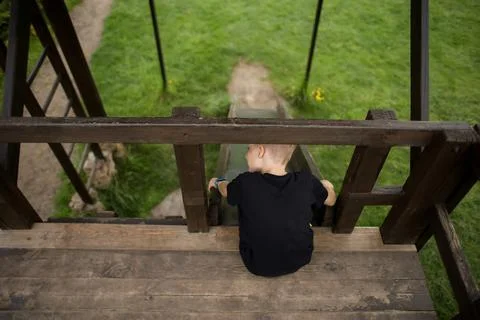 The boy goes through an obstacle course, goes in for active sports, sits on t Stock Photos
