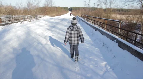 Boy goes on winter road Stock Footage 68108109