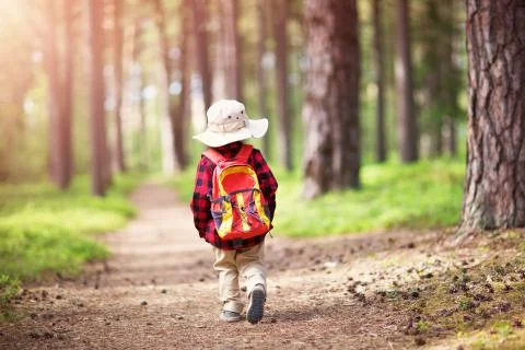 Boy going camping with backpack in nature Stock Photos