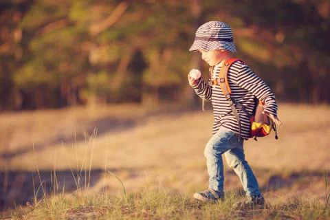 Boy going camping with backpack in nature Stock Photos