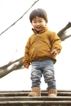 Boy going down the stairs Stock Photos