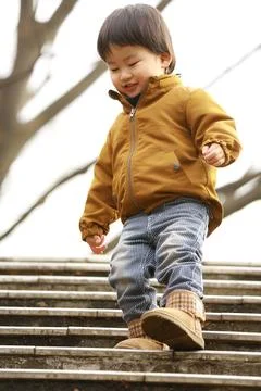 Boy going down the stairs Stock Photos