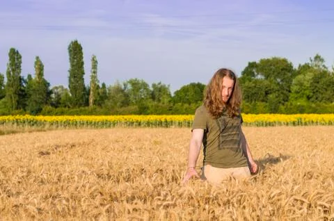 Boy at grain field at sunset Stock Photos