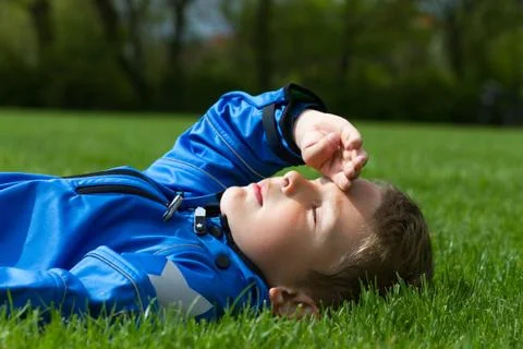 Boy on grass Stock Photos