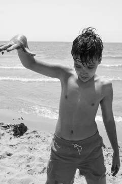 Boy with green eyes on the beach Stock Photos