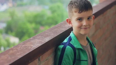 A boy in a green windbreaker posing for the camera Stock-Footage 108626367