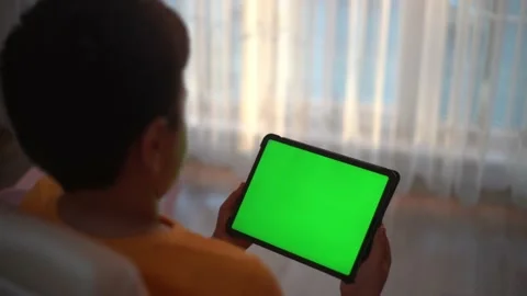 Boy greenscreen tablet playing Stock Footage 144674688