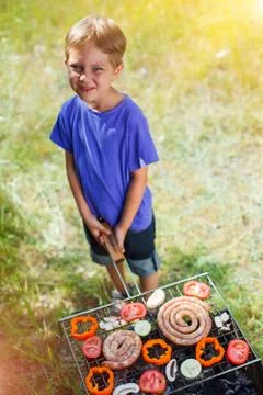 Boy grilling vegetable Foto stock