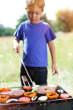 Boy grilling vegetable Foto stock