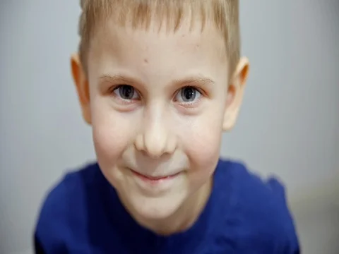 The boy grimaces and blinks Stock Footage 73602141