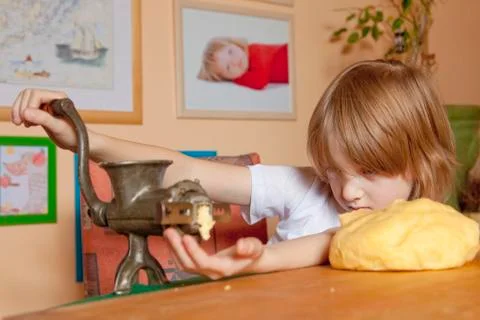 Boy Grinding Flour Stock Photos