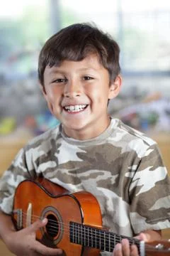 Boy with guitar Stock Photos