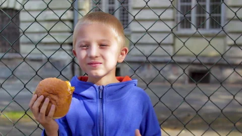 Boy with a hamburger Stock Footage 148264808