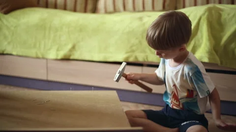 The boy is hammering nails with a hammer Stock Footage 67349920