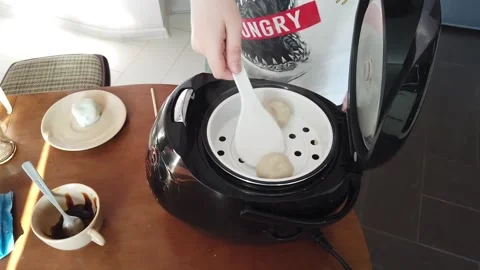 Boy Hand upload balls from multicooker in saucer. Stock Footage 152103551