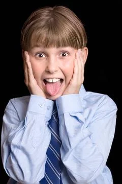 Boy hands to face expression Wide-eyed child screams and places hands to f... Stock Photos
