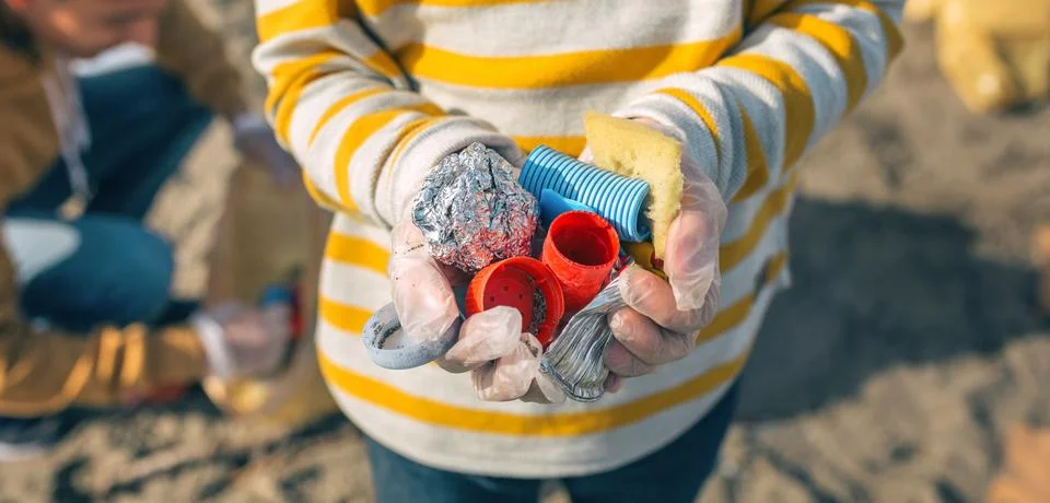 Boy hands with garbage from the beach Stock Photos