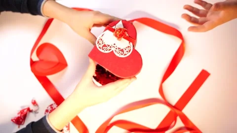 Boy hands gives Valentines Day gift heart shaped box with card Stock Footage