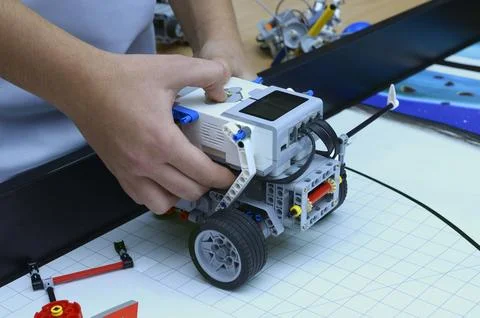 Boy hands launching robot made of plastic blocks Stock Photos