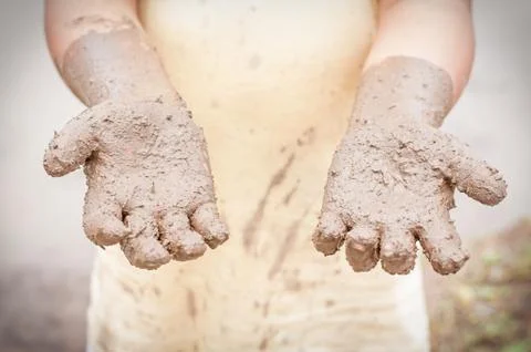 Boy hands with mud Stock Photos