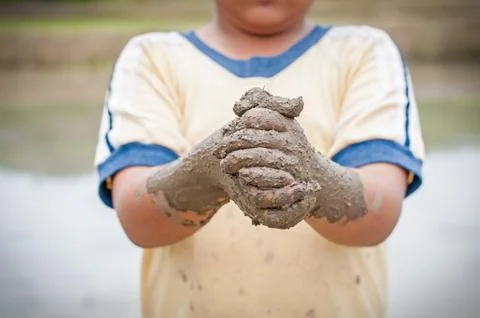 Boy hands with mud Stock Photos