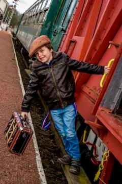 Boy hanging on the side of a train Stock Photos