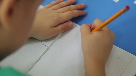 The boy hardly writes in a notebook, letters and numbers 库存影片 53747419