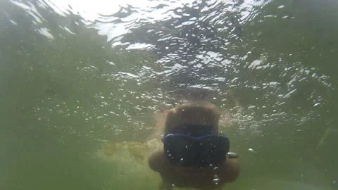 Boy has fun diving underwater Stock Footage 144664693