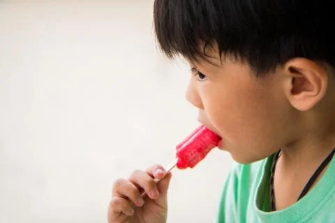 Boy has satisfied when he eat favorite ice cream Stock Photos