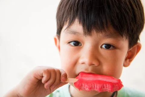 Boy has satisfied when he eat favorite ice cream Stock Photos