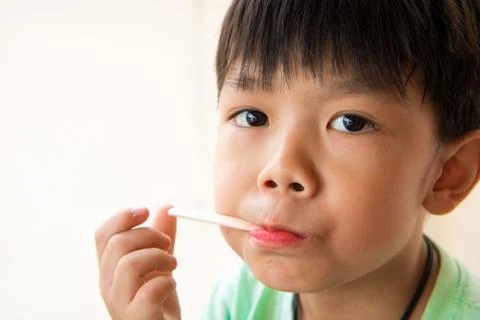 Boy has satisfied when he eat favorite ice cream Stock Photos