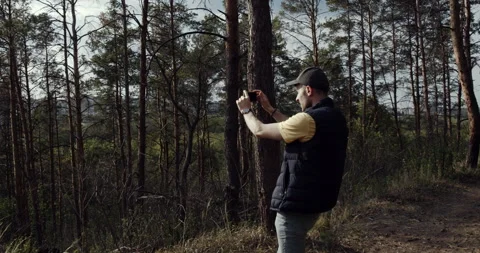 A boy with a hat on his head, walking in the city park at sunset Stock Footage 138586925
