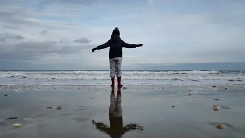 Boy with a hat playing on the beach Stock Footage 181471137