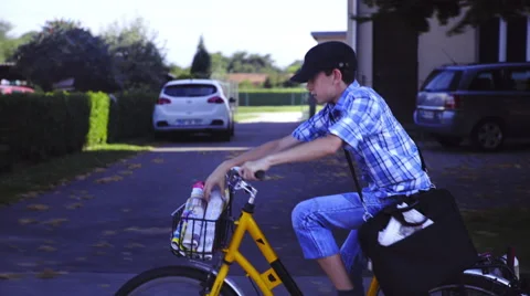 Boy with hat throwing newspaper while driving 4K Stock Footage 54055882