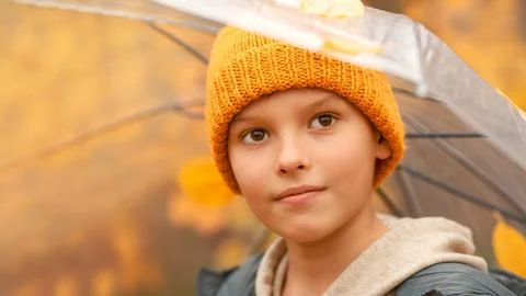 Boy in a hat with a transparent umbrella Stock Photos