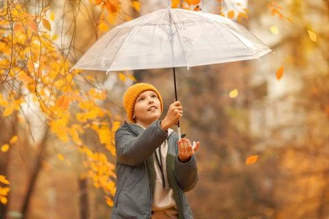 Boy in a hat with a transparent umbrella Stock Photos
