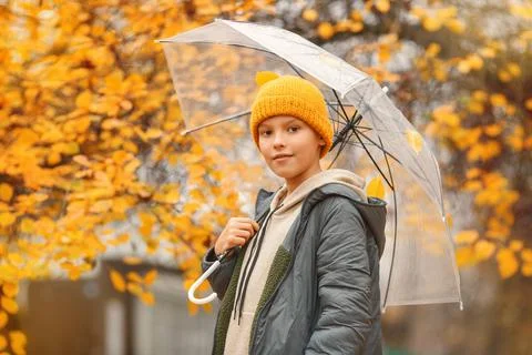 Boy in a hat with a transparent umbrella Stock Photos