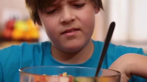 Boy hate eating vegetables salad Video stock 80104469