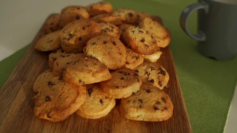 Boy have breakfast in modern kitchen. Boy eat cookie with milk. White Table in Video stock 103676844