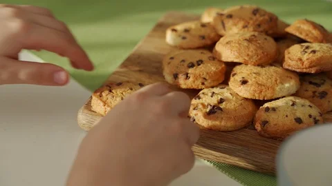 Boy have breakfast in modern kitchen. Boy eat cookie with milk. White Table in Video stock 103682783