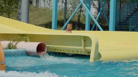 Boy have fun in a closed water slide at Aqua Park. Stock Footage 299917148